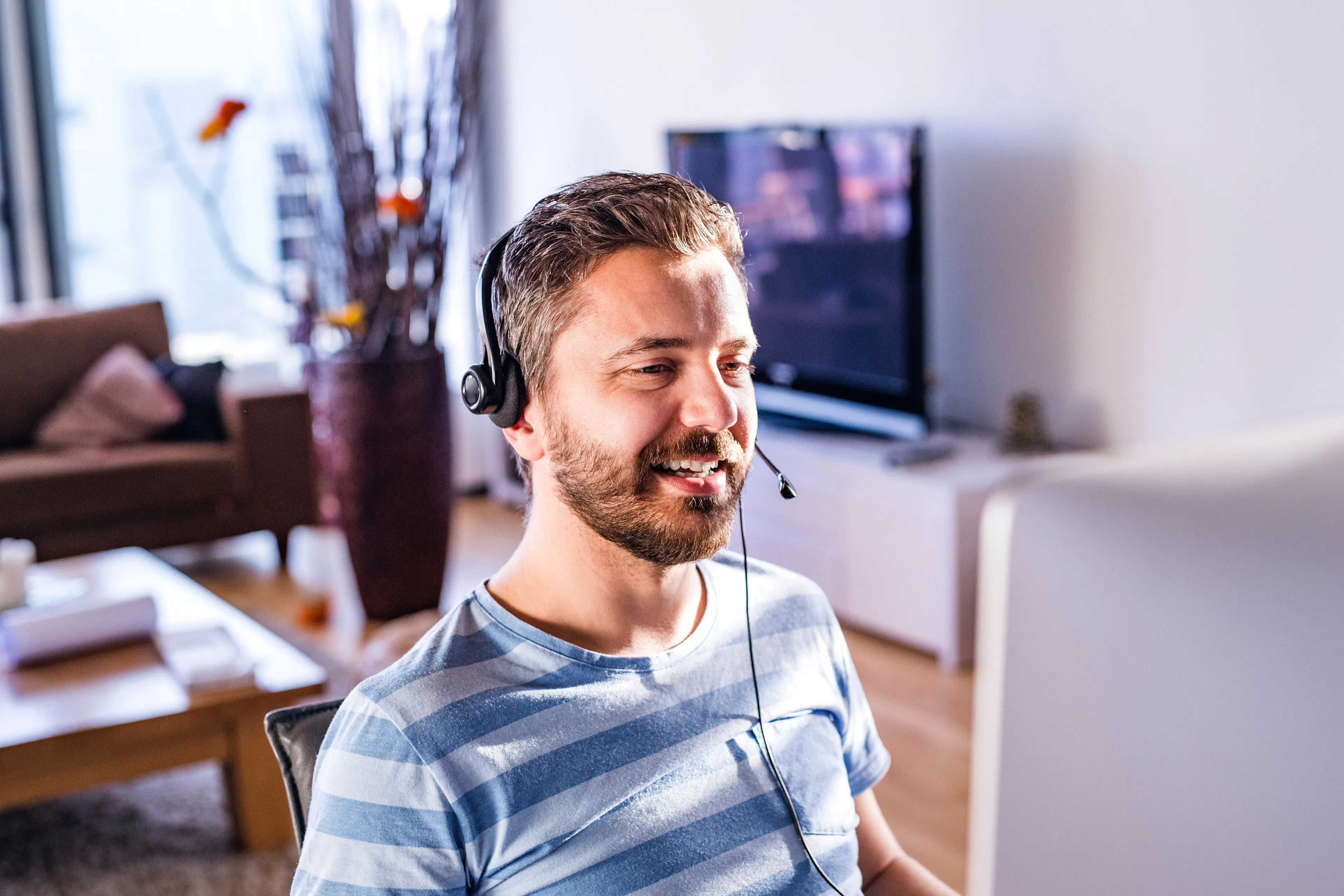 Man working from home with a customer-service headset