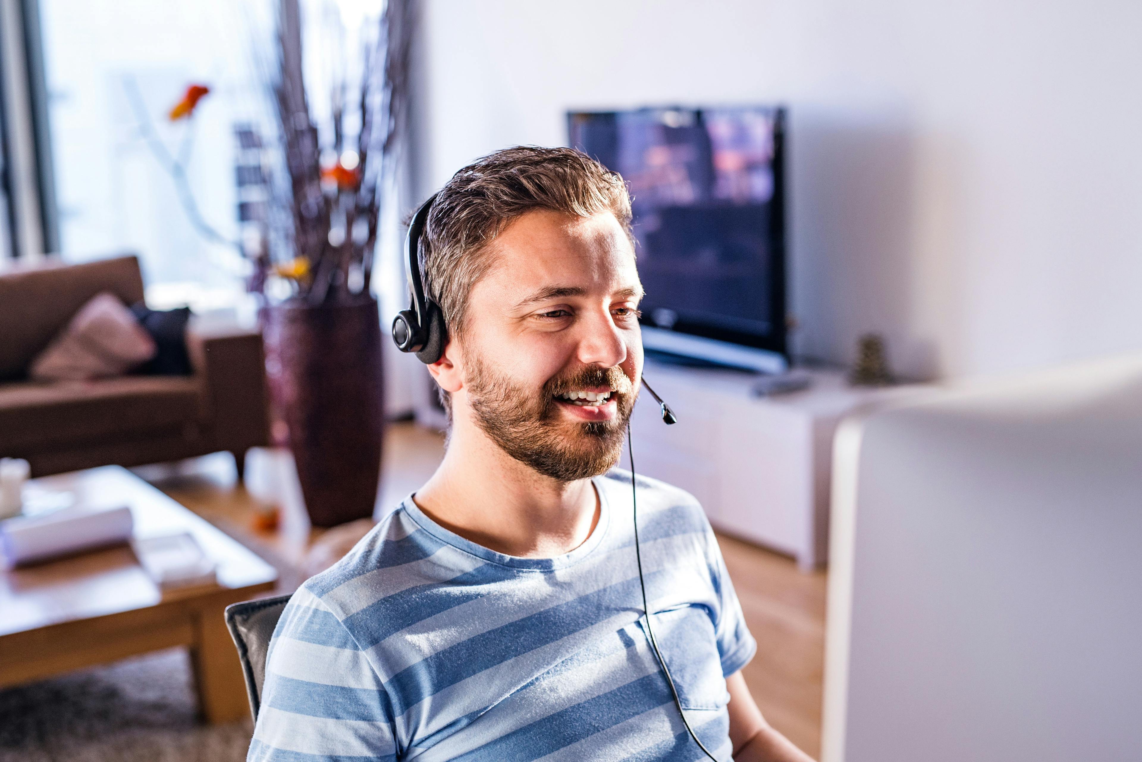 Man working from home with a customer-service headset